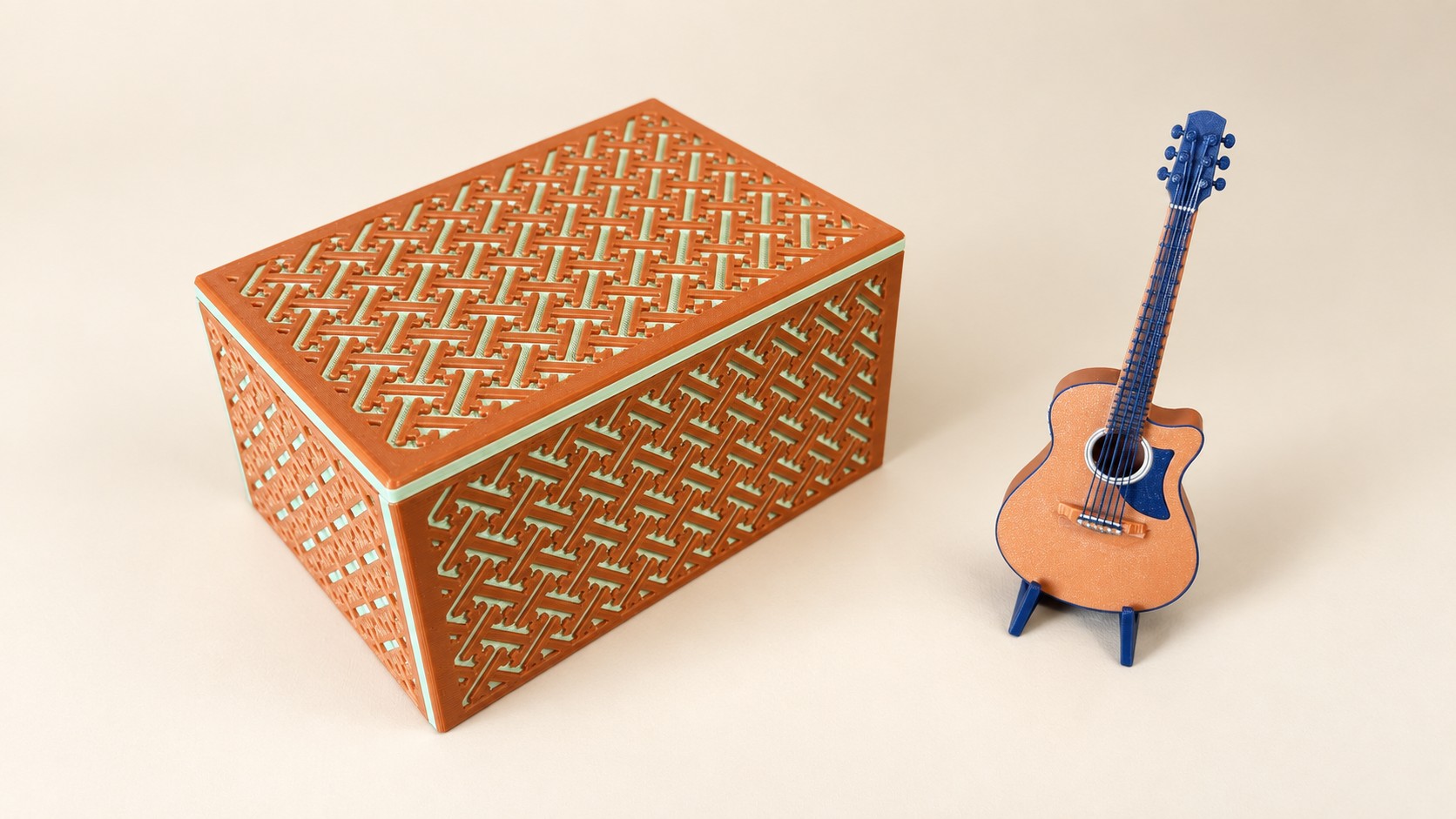 Copper and mint patterned box beside a miniature acoustic guitar.