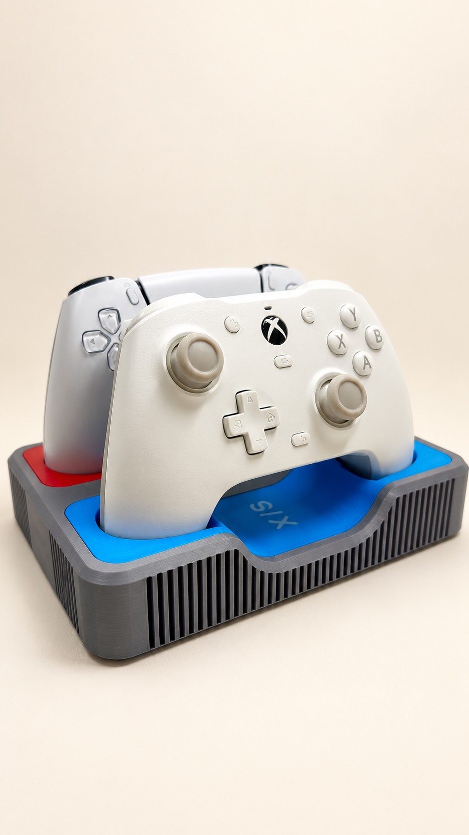 Grey controller organizer with blue and red inserts holding two white gaming controllers.