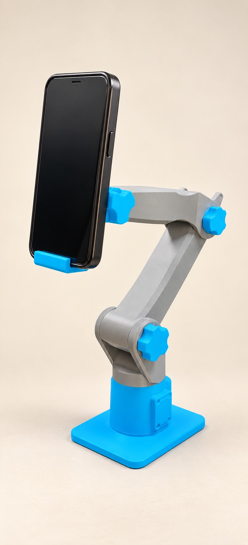 Grey and cyan articulated stand holding a phone upright.